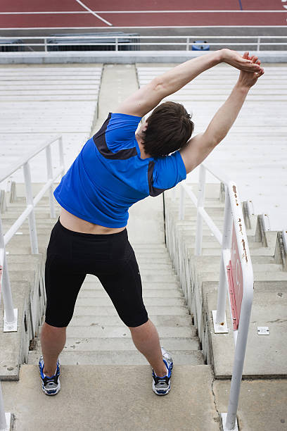 Track and field stretching athlete stock photo