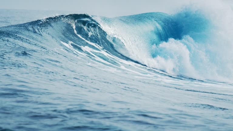 Ocean wave rolls and breaks on the shore in the Maldives