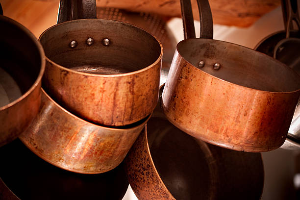 istock Aged copper pots and pans hanging on a rack 147296091