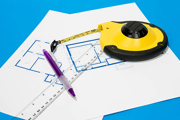 Measuring tape and house plan stock photo