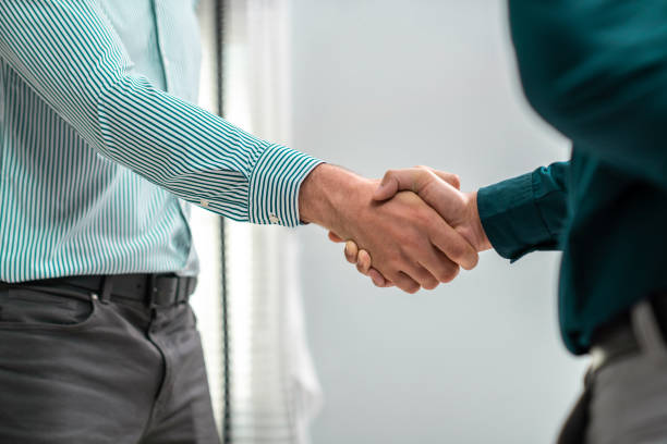 istock Two competent businessmen shake hands to each other. 1472961280