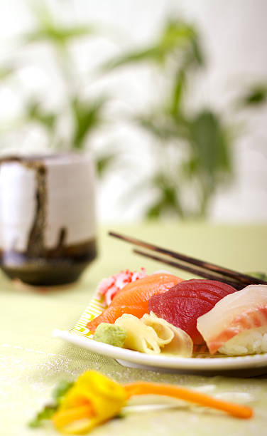 sushi and tea Delicious Nigiri and tea, focus on the tuna. salmon and red snapper stock pictures, royalty-free photos & images