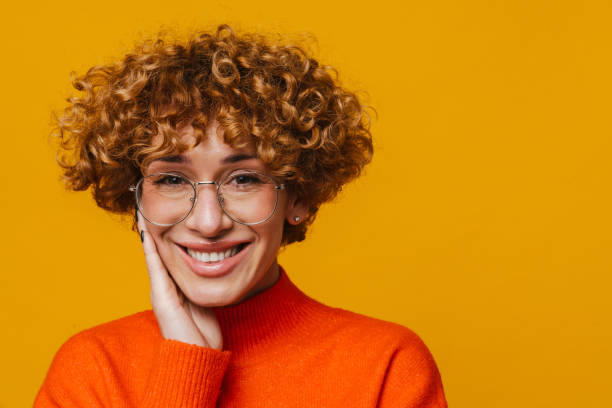 istock Middle-aged ginger woman smiling while standing isolated over yellow background 1472963661