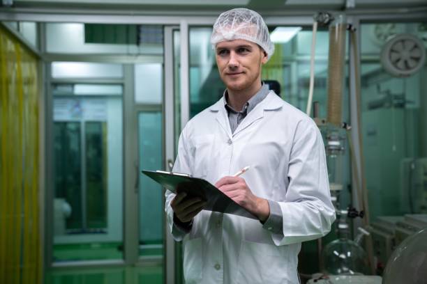istock Apothecary scientist recording data from CBD oil extractor in laboratory. 1472964072