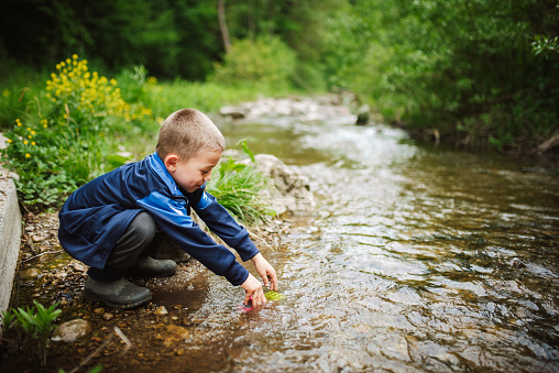 Boy playing by the river.