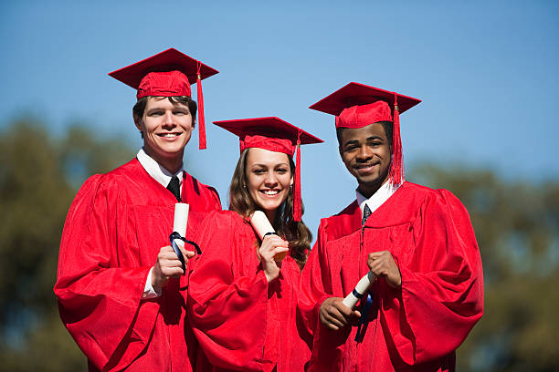 Three Multi-Ethnic Friends On Graduation Day stock photo