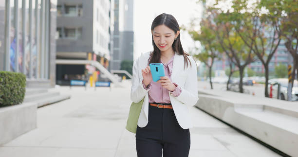istock businesswoman use mobile 1472965589
