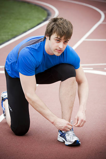 Runner lacing his shoe stock photo