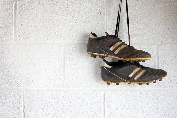 Photo of Pair of muddy black football boots