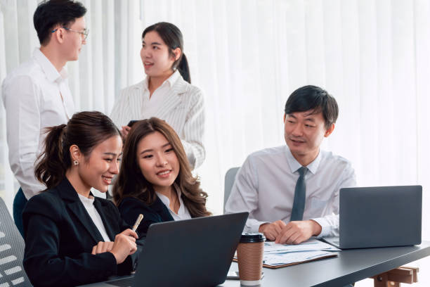 istock Office worker and manager analyze financial report paper in harmony workplace. 1472970880