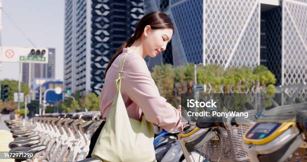 Woman Rent A Bike Commute Stock Photo - Download Image Now - Asia, Bicycle Sharing System, Cloud Computing