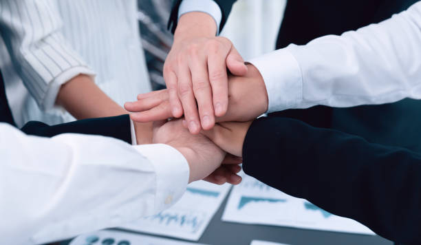 istock Top view closeup business team join hand stack together for harmony concept. 1472972054