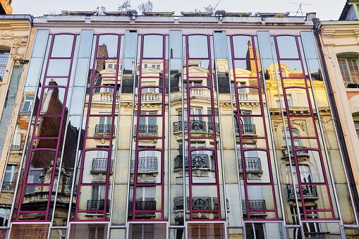 picture of an old building reflecting in a mirror facade in Lille, France