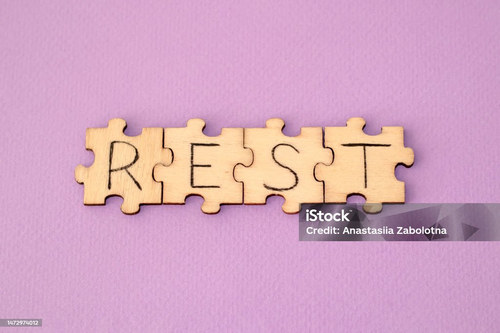 Learning Rest. The hand lettering on the wooden puzzles is on a purple background Learning Rest. The hand lettering on the wooden puzzles is on a purple background. Application Programming Interface Stock Photo