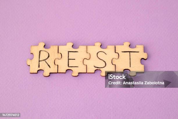 Learning Rest The Hand Lettering On The Wooden Puzzles Is On A Purple Background Stock Photo - Download Image Now