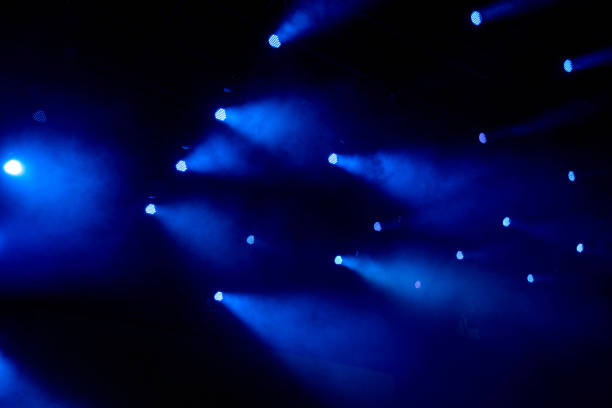 istock abstract magic image with rays of colored light from the spotlights in the dark 1472975153