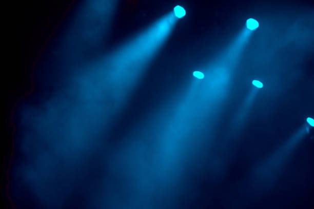 istock abstract magic image with rays of colored light from the spotlights in the dark 1472975195