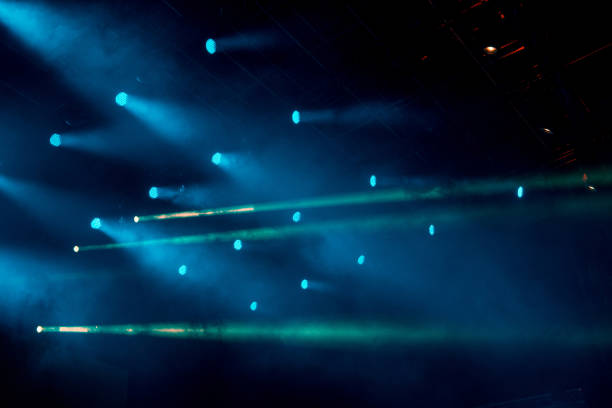 istock abstract magic image with rays of colored light from the spotlights in the dark 1472975196