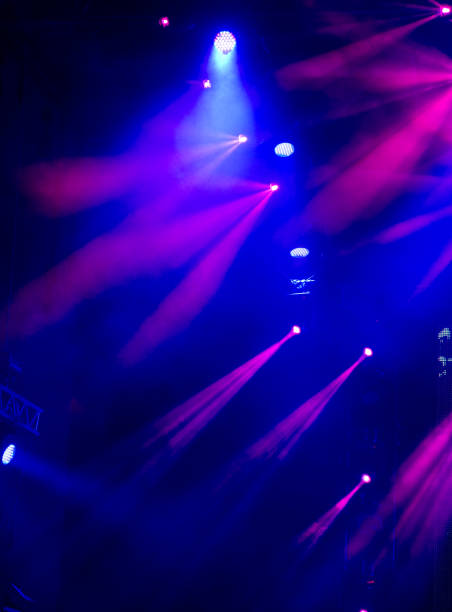 istock abstract magic image with rays of colored light from the spotlights in the dark 1472975253