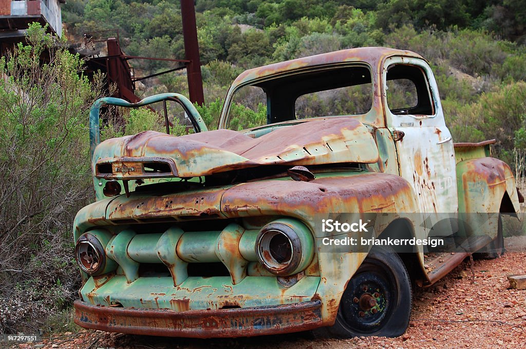 Old Rusted Truck A colorful rusted pickup truck grounded outside of an old mine in Santa Barbara, CA. Color Image Stock Photo
