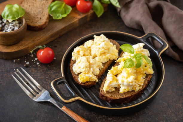 istock Scrambled eggs on whole grain bread. Homemade breakfast or brunch meal - scrambled eggs. 1472975964