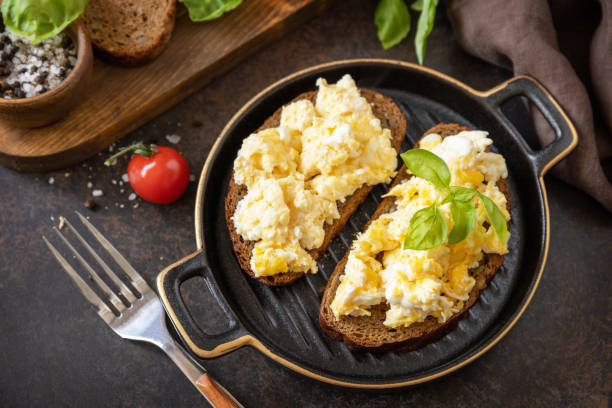 istock Scrambled eggs on whole grain bread. Homemade breakfast or brunch meal - scrambled eggs. 1472975968