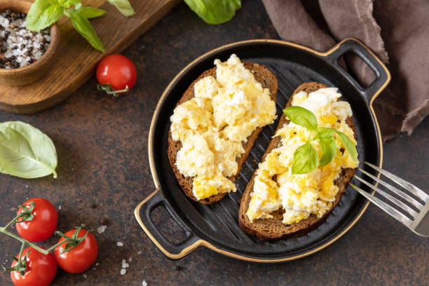 istock Scrambled eggs on whole grain bread. Homemade breakfast or brunch meal - scrambled eggs. 1472975971