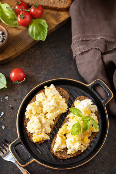 istock Scrambled eggs on whole grain bread. Homemade breakfast or brunch meal - scrambled eggs. Copy space. 1472975974
