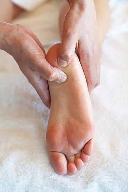 Reflexologist Therapeutic Foot Massage stock photo