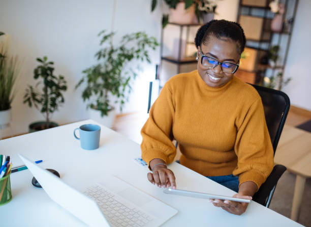 istock African entrepreneur working in office on laptop 1472977348