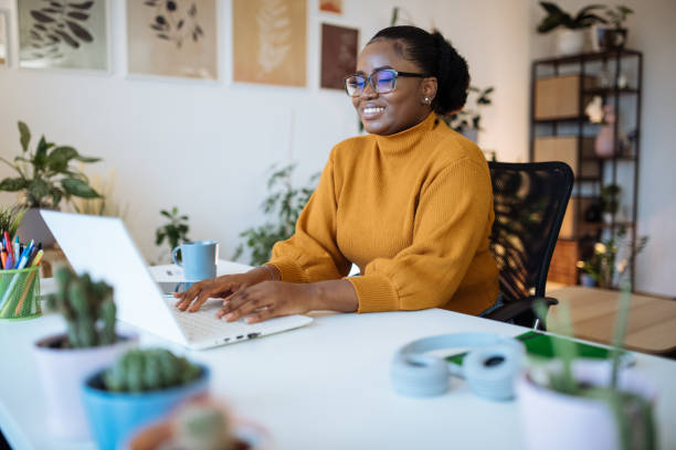 istock African entrepreneur working in office on laptop 1472977388