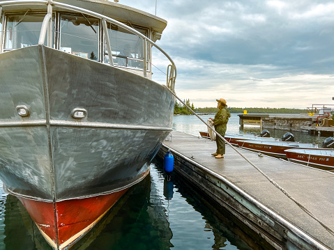 Isle Royale National Park, Michigan, USA, August 24, 2022 A Ranger with the National Park Service greets a visitor aboard a ferry boat.