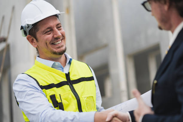 istock Happy caucasian engineer man check hand with manager in precast site work 1472977885