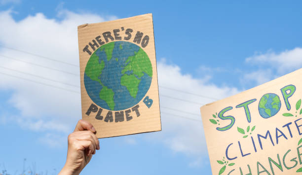 istock Protesters with placard signs There's no planet B and Stop Climate Change. Global warming strike. 1472978198
