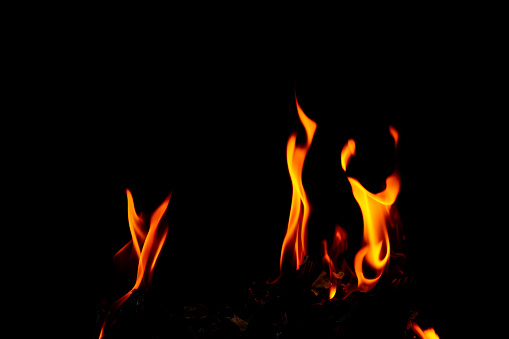 Fire flame glow and burning on dark black background