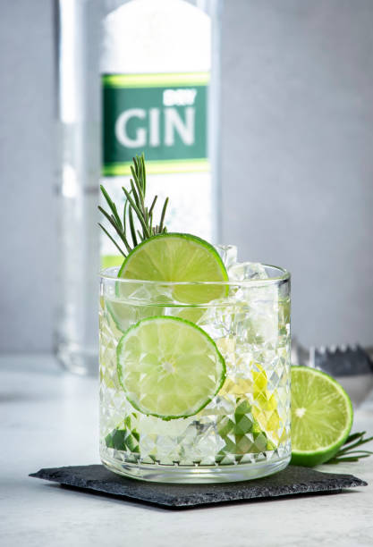 istock Gin tonic classic cocktail drink with dry gin, bitter tonic, lime and ice. Gray table background 1472978978