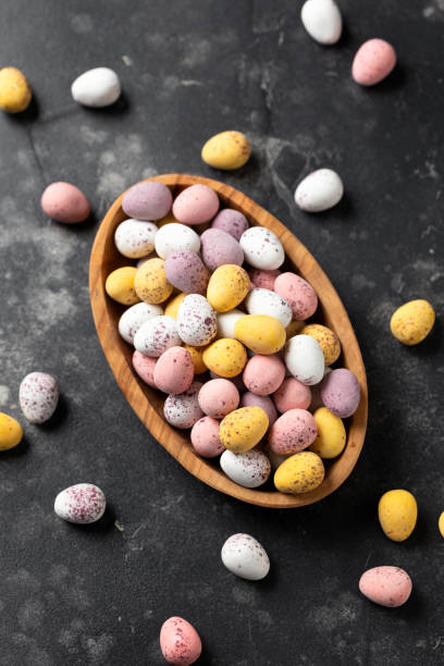 istock Easter mini eggs, chocolate candy in wooden bowl 1472979775