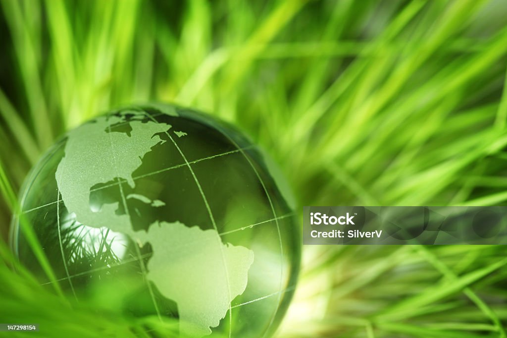Glass Earth ball on green grass Glass earth in grass Backgrounds Stock Photo