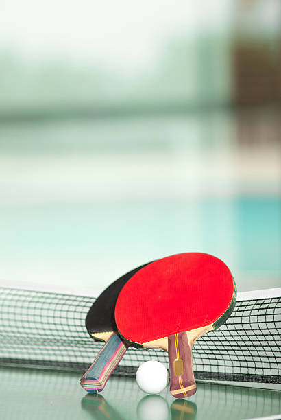 Ping-Pong rackets and ball on table stock photo