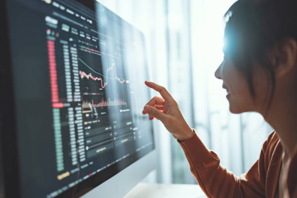istock Closeup - Woman is checking Bitcoin price chart on digital exchange on computer screen, cryptocurrency future price action prediction. 1472987871