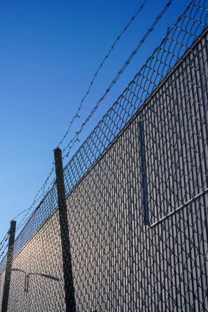 istock Low angle view of barbed wire fence against clear sky 1472991422