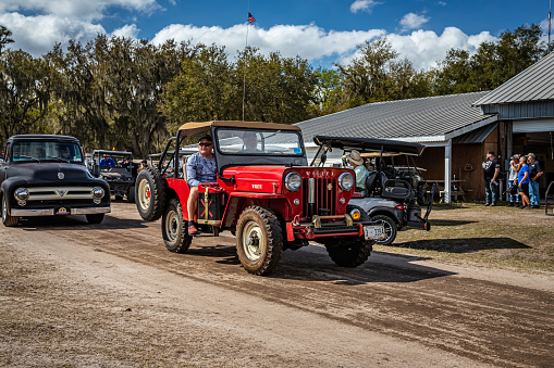 Fort Meade, FL - February 26, 2022: Wide angle front corner view of a 1959 Willys Jeep CJ-3B at a local car show.