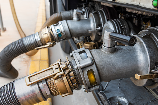 Devices attached to the mouths of a tanker truck to connect the discharge hoses,discharging diesel and gasoline.