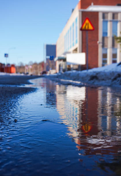 Reflection of a building in a frozen puddle