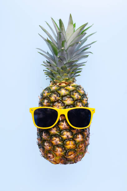 istock Pineapple with sunglasses on blue background 1472993297