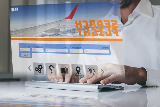 istock Man search ticket vacation on virtual display laptop. Booking flight. Plan travel and book holidays. 1472993557