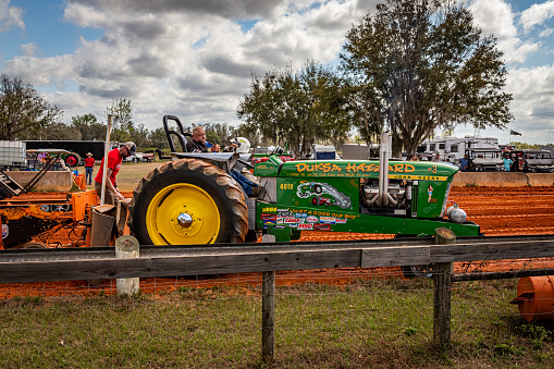 Fort Meade, FL - February 26, 2022: Wide angle side view of a 1963 John Deere 4010 Tractor Puller at a local tractor pulling competition.