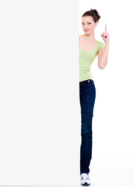 istock girl look out from blank banner 147299409