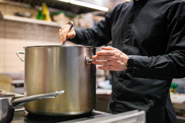 istock chef pouring tasty soup from big pot into bowl on restaurant kitchen 1472994129
