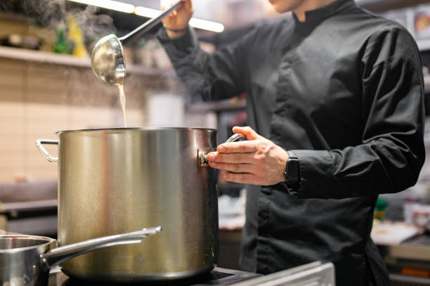 istock chef pouring tasty soup from big pot into bowl on restaurant kitchen 1472994136